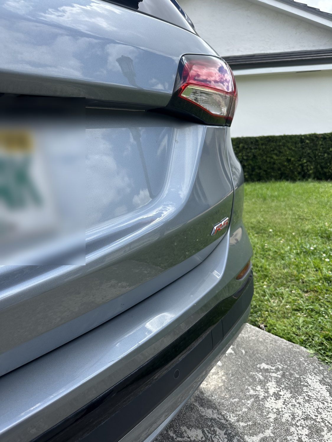 Dent on a quarter panel before paintless dent repair, Miami