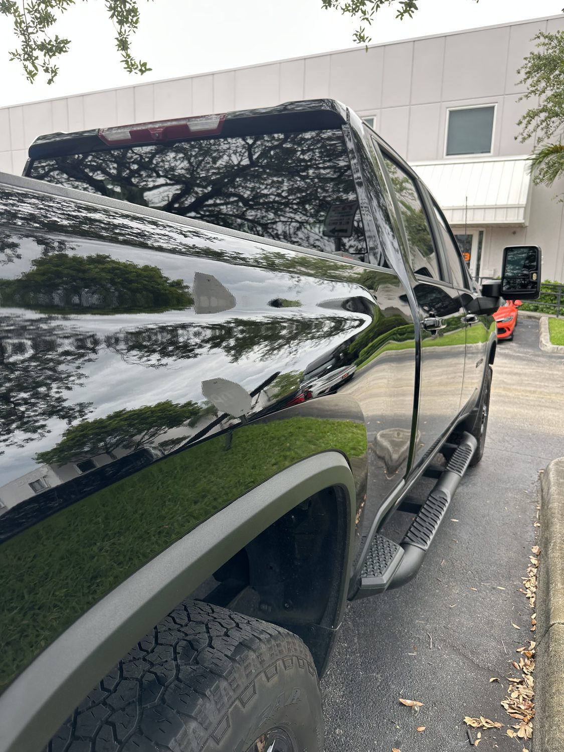 On-site paintless dent repair on a black panel, Miami