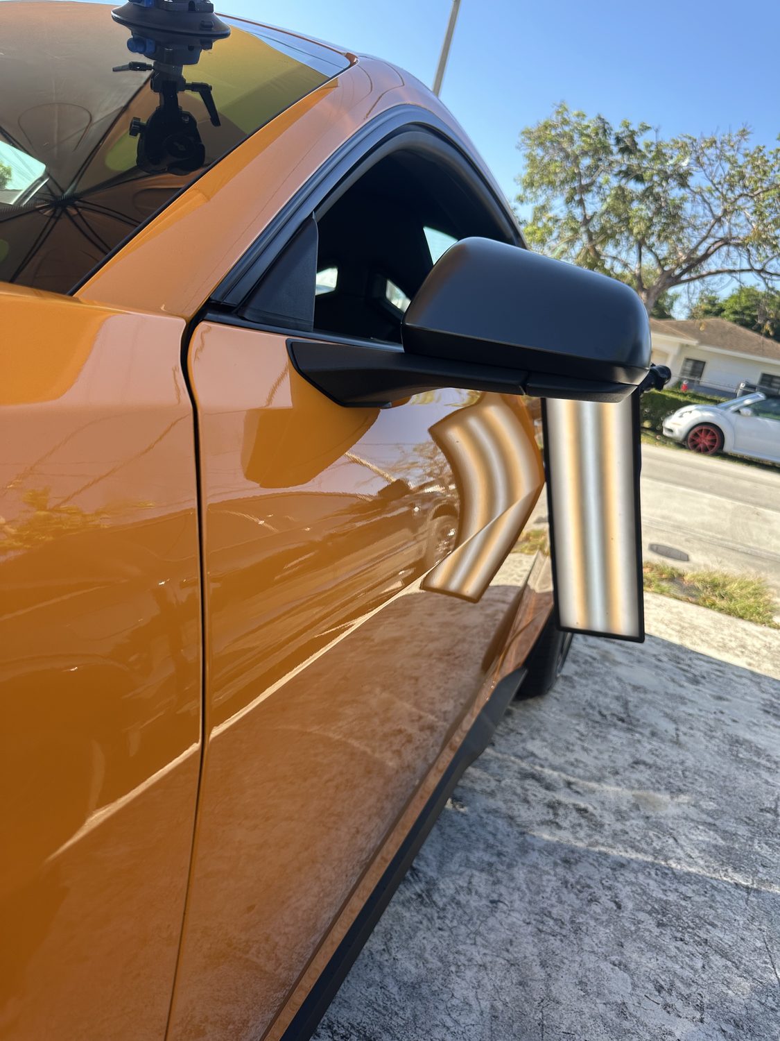 Dent near the mirror on a bronze door panel, Miami